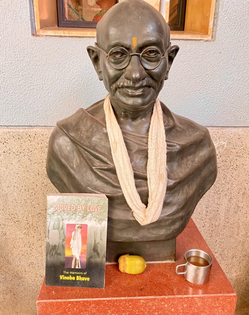 Bust of Mahatma Gandhi at ESI in Ahmedabad, with the book Moved by Love beside it
